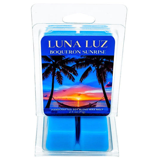 Luna Luz Boqueron Sunrise wax melt packaging showing two palm trees and a hammock in between trees with a sunrise in the background. Wax melt set on a white background.
